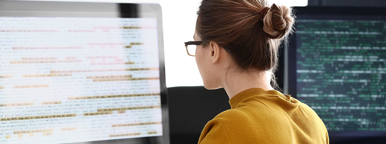 Woman looking at code on computer